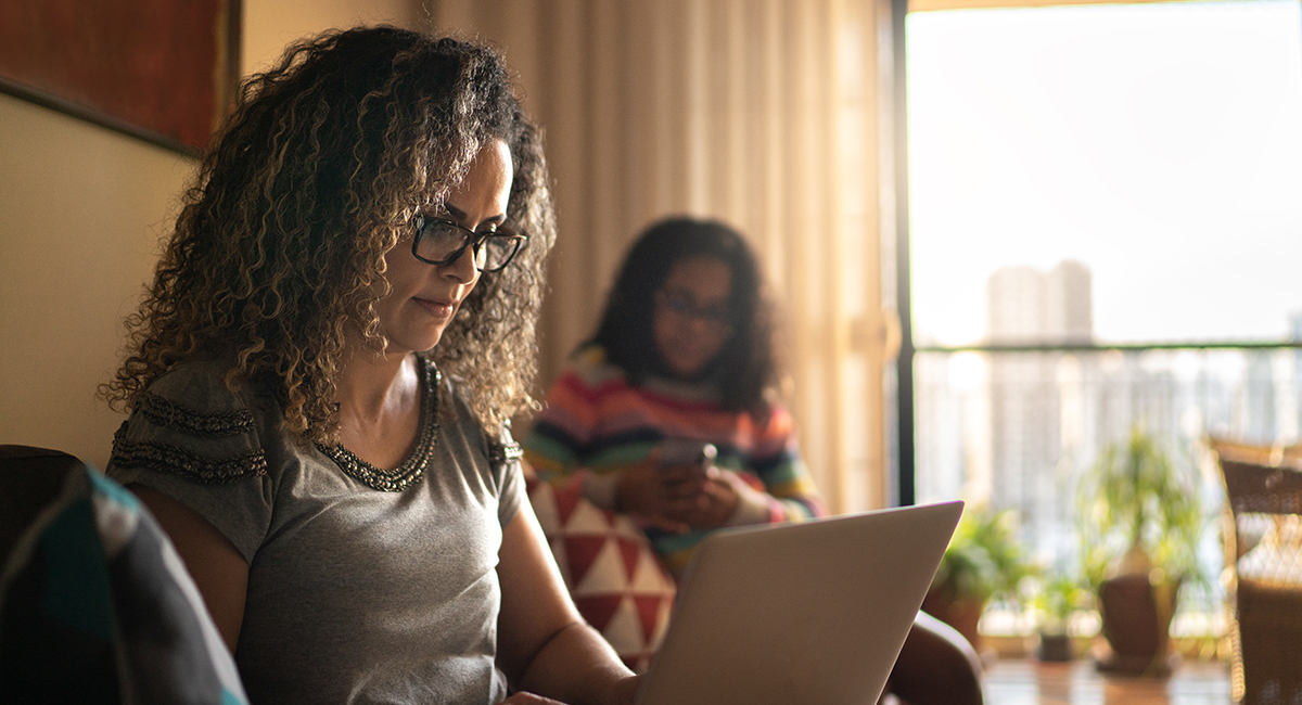 woman on couch using laptop